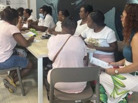 Mujeres afrodescendientes sentadas en mesa socializando entre ellas